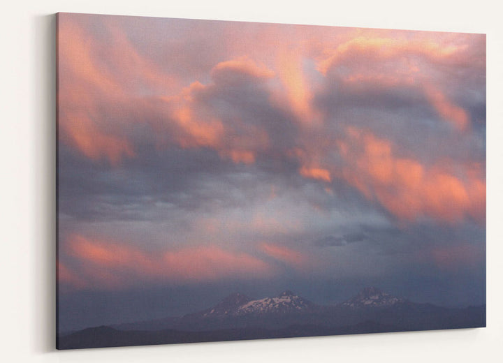 Pink or purple colored clouds at sunset over the Three Sisters, Oregon